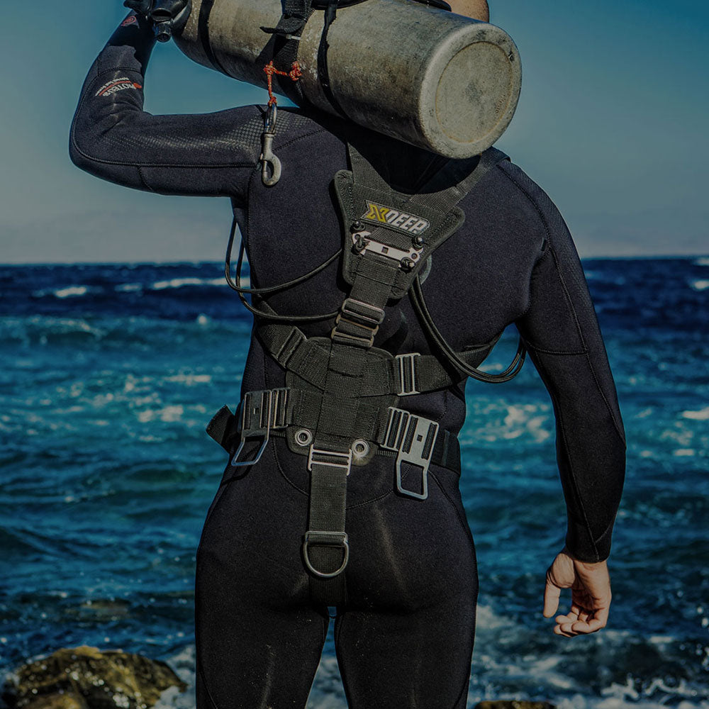 Diver wearing XDeep Stealth 2.0 Classic Redundant Bladder Sidemount System Black